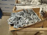 many pieces of metal in a cardboard box on the floor