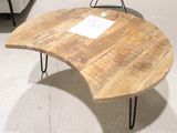 a wooden table with hairpin legs and a sign on it
