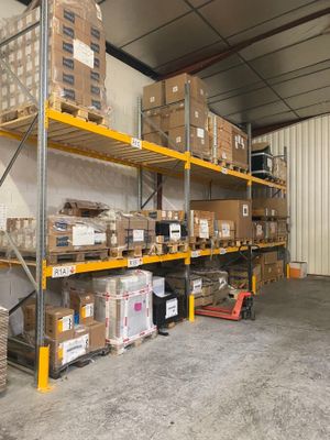many boxes on the shelves in the warehouse