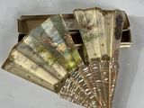 a gold fan that is sitting on top of a white table