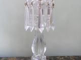 a clear glass candle holder with a candle on top of it