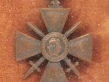 a medal with a cross on it sitting on a table