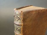 an old book sitting on top of a wooden table