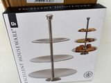 the box is full of three tiered trays on a table