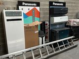 a lot of appliances that are stacked up in a warehouse