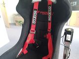 a car seat that has a red seat belt attached to it