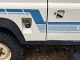 a white truck with a blue stripe on the side of it