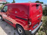 the red van is parked on the side of the road