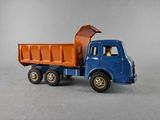 a blue and orange toy truck with a man in the back