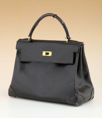 a black leather handbag with gold hardware on the handle