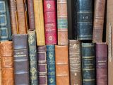 a box full of old books sitting on the floor