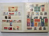 an open book with stamps on it on a table