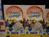two boxes of alhambra crackers sitting on a shelf in a store
