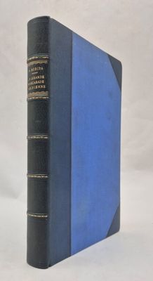 an old book with a blue cover sitting on top of a white table
