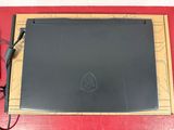 a black laptop computer sitting on a red surface