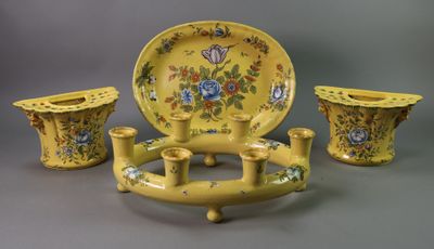 three pieces of yellow pottery on display on a table