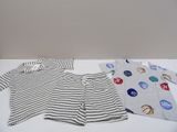 three pieces of clothing on a table with buttons on them