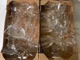 two empty wine glasses in a box on a table