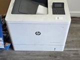 a white printer sitting on the floor next to a box