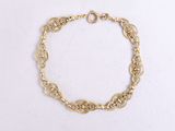 a close up of a gold chain bracelet on a white background