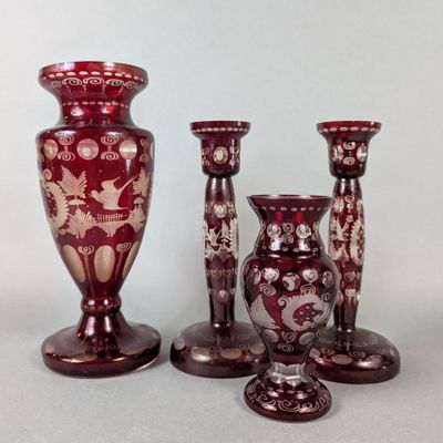 three red vases sitting next to each other on a table