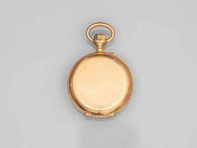 an old gold pocket watch with a chain hanging from it ' s side