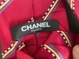 chanel label on a red tie with multicolored stripes