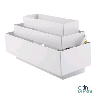 a white box with three compartments and a pen in it
