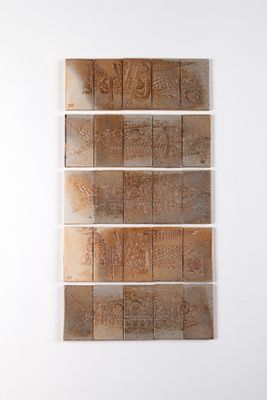 four pieces of wood are stacked on top of each other on a white wall