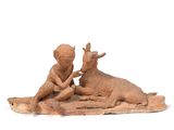 figurine of two children playing with a cow on a rug