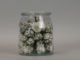 a glass jar with shells in it on a table