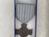 two medals and a medal in a box on a table
