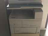 a printer sitting on top of a stack of boxes