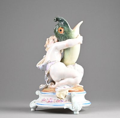 a figurine of a woman holding a fish on top of a table