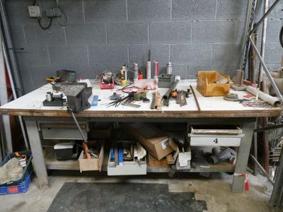a workbench with many tools on it in a garage