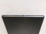 the back of a tablet computer sitting on top of a white table