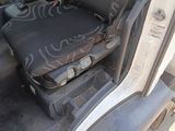 a seat in the back of a truck with graffiti on it