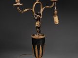 an image of a black and gold table lamp with a bird on it