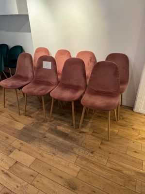 several chairs are lined up in a row on a wooden floor
