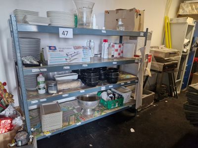 a metal shelf with many items on it in a room