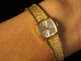 a woman ' s wrist that has a watch on it