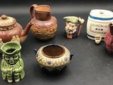 many different types of vases sitting on a table
