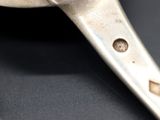 a close up of a spoon with a handle on a table