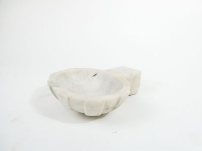 a white marble bowl sitting on a white surface