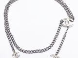 a close up of a chain with two charms attached to it