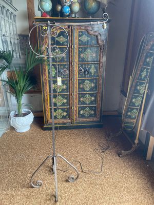 a tall stand with a bunch of decorative objects on it