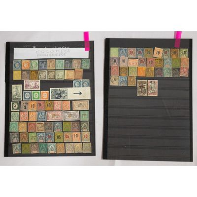 two framed photographs of stamps on a white wall with pink tape
