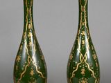 pair of green and gold vases on a gray background