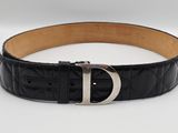 un gros plan d'une ceinture noire avec une boucle argentée