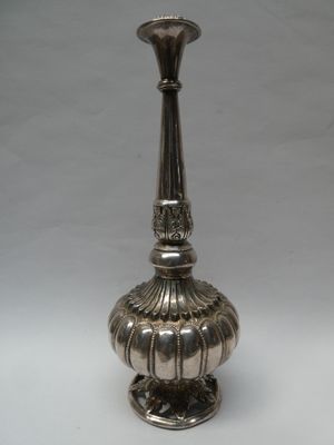 an image of a silver vase sitting on top of a white table